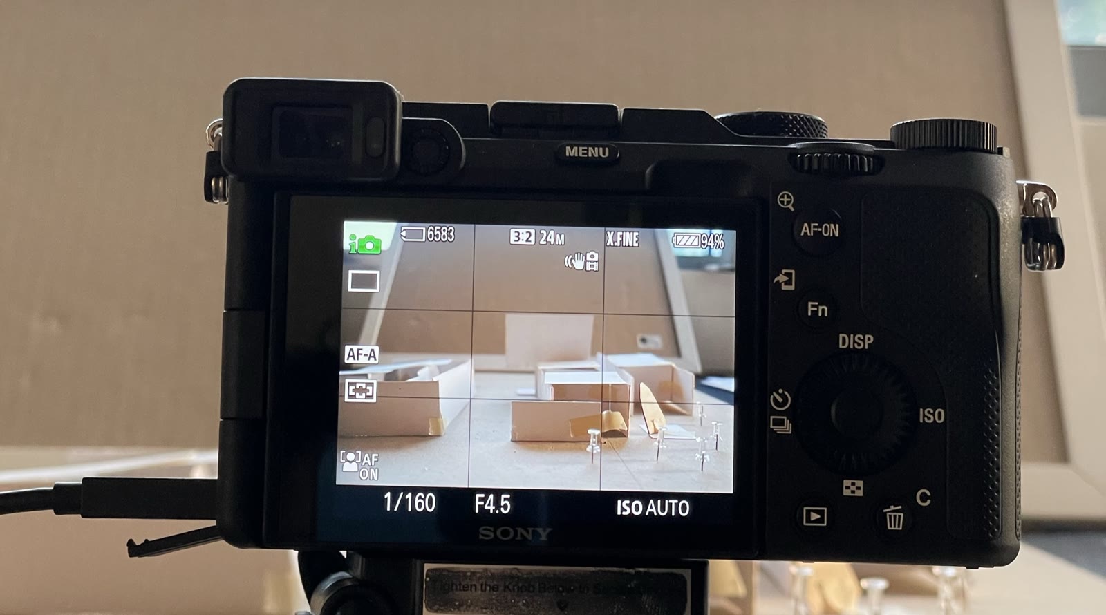 DSLR viewfinder framing rough chipboard and paper massing